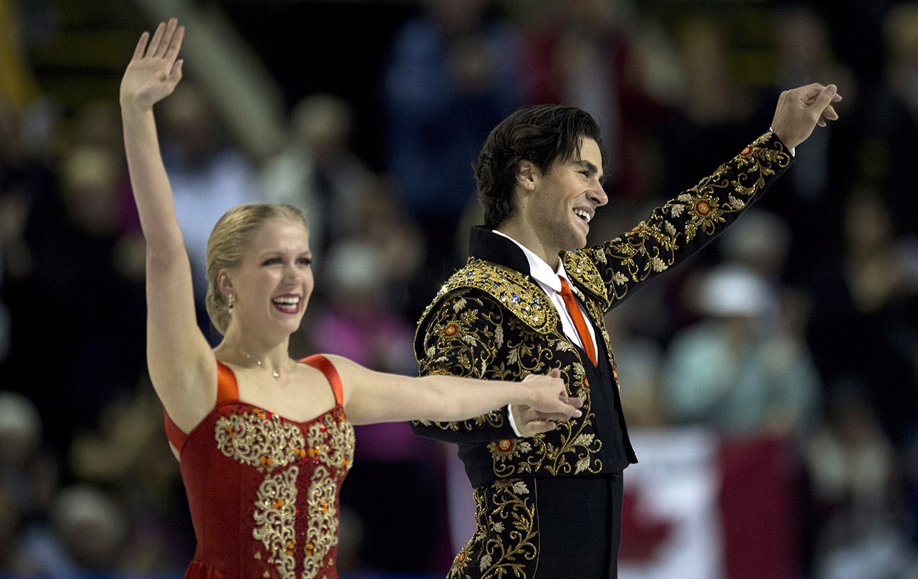 Kaitlyn Weaver and Andrew Poje salute the crowd after their short dance.