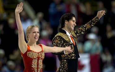 Kaitlyn Weaver and Andrew Poje salute the crowd after their short dance.