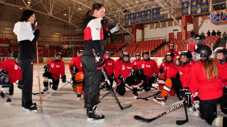 Ward (standing, right), is a two-time Olympic champion in women's ice hockey.