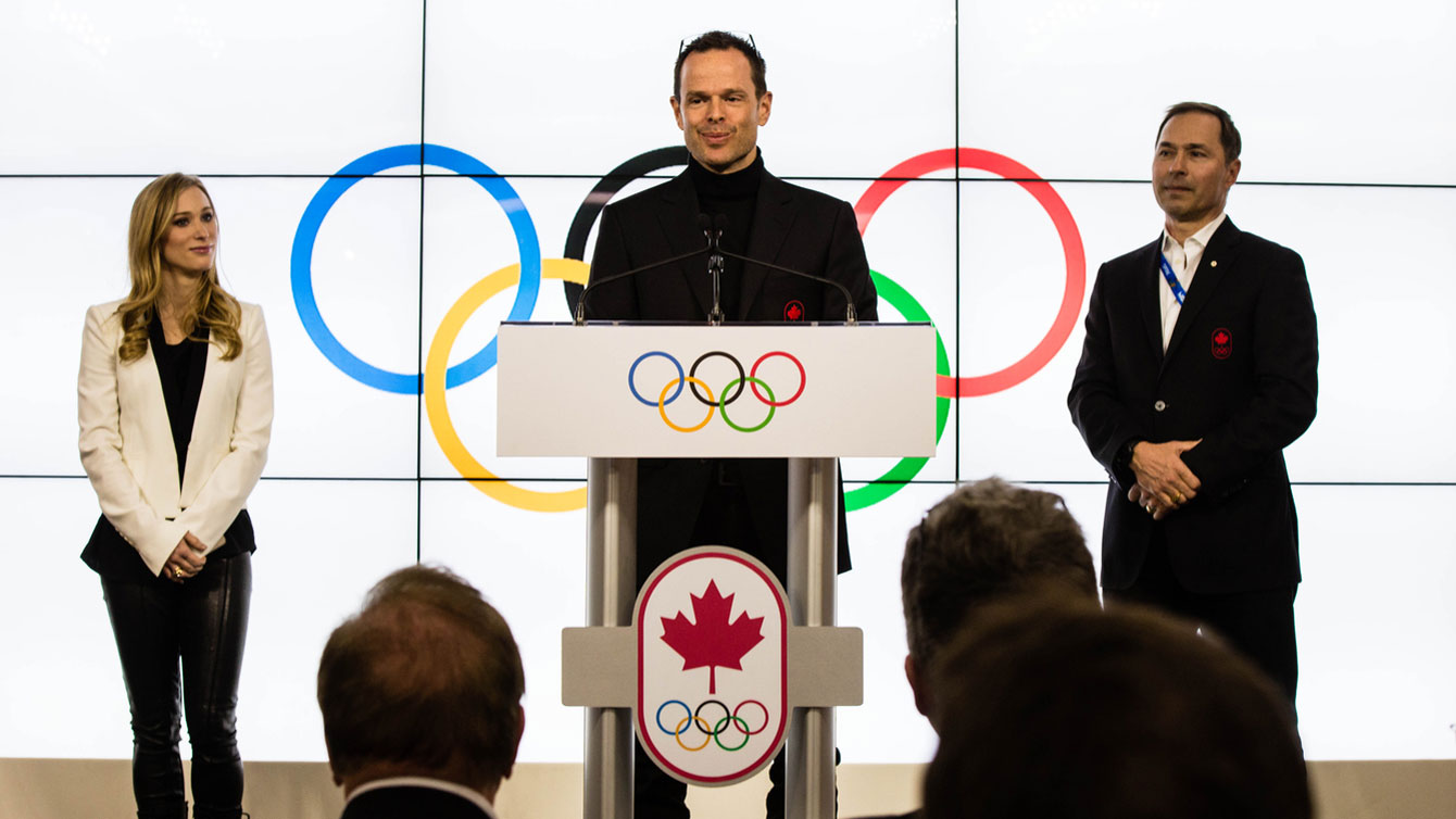 Brassard, flanked by Sochi 2014 Chef de Mission Steve Podborski (right) and Olympic medallist figure skater Joannie Rochette at Canada Olympic House. 