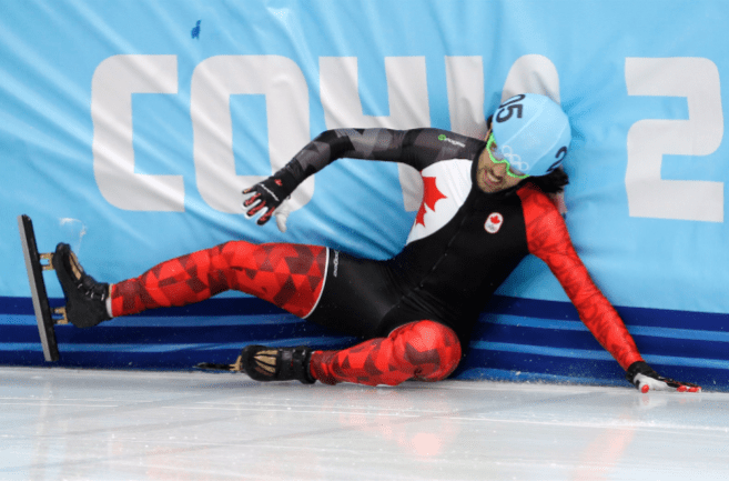 Charles Hamelin of Canada crashes out in a men's 500m short track speedskating heat at the Iceberg Skating Palace during the 2014 Winter Olympics, Tuesday, Feb. 18, 2014, in Sochi, Russia. (AP Photo/David J. Phillip )