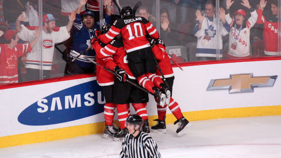 Anthony Duclair piles on as Canada celebrates Max Domi's opening goal. 