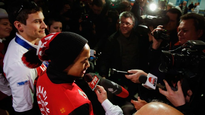 Morrison (left) and Junio meet an awaiting Canadian media at the airport upon their return from Sochi.