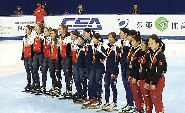 Canadian women - including skaters who competed in the heats - collect the relay bronze in Shanghai.