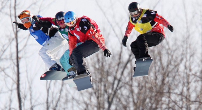 Carle Brenneman (yellow) grabs air during a World Cup race. (Photo: Canadian Press)