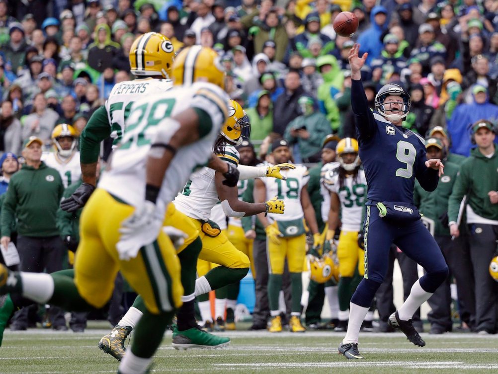 Punter Jon Ryan releases his historic touchdown pass for the Seahawks' first points of the 2015 NFC Championship. (Photo: Canadian Press)