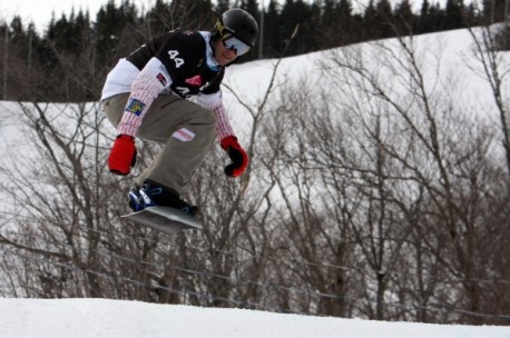 Rob Fagan grabbing some air mid-race. (Photo: Canada Snowboard)