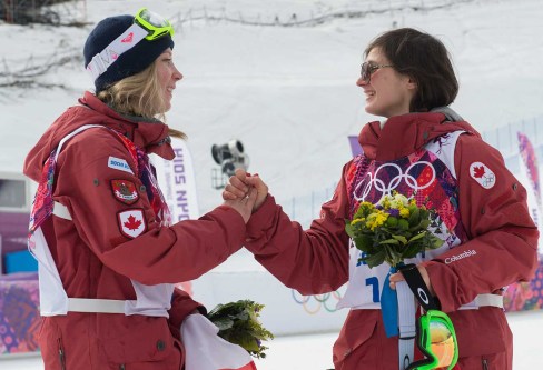 Dara Howell (L) and Kim Lamarre (R) celebrate their gold and bronze medals during the flower ceremony for ski slopestyle.