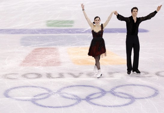 Canada's Tessa Virtue and Scott Moir salute the crowd following their compulsory dance in the ice dance competition Friday February 19, 2010 at the 2010 Vancouver Olympic Winter Games in Vancouver. THE CANADIAN PRESS/Paul Chiasson