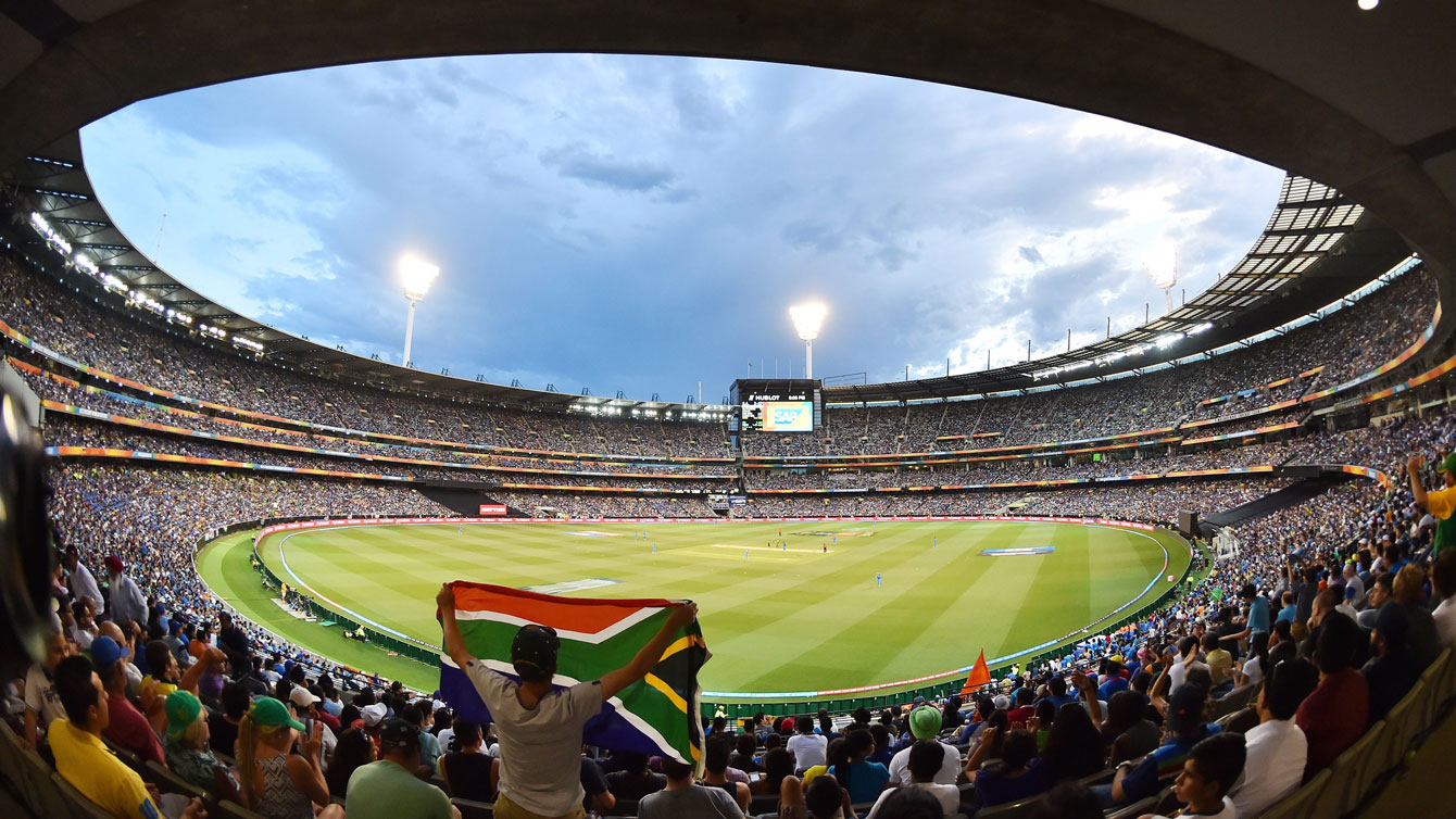A South Africa fan holds up a large flag at the 100,000-seat Melbourne Cricket Ground in Australia during the 2015 Cricket World Cup. 