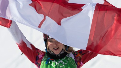 Dominique Maltais celebrates with the flag after her medal-winning run.