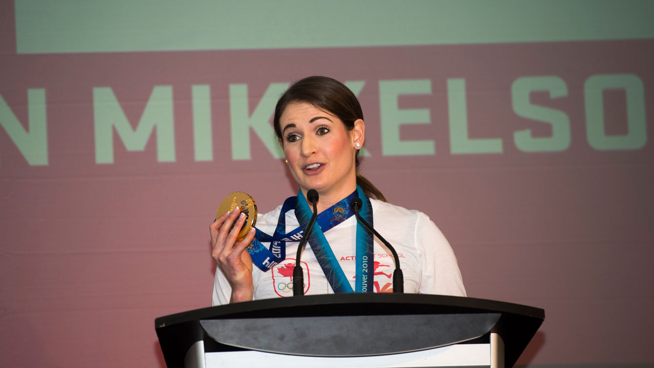 Meaghan Mikkelson holds up one of her two Olympic gold medals. 