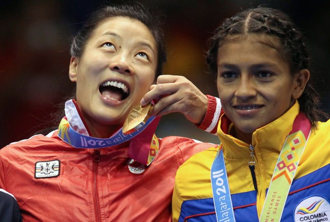 Carol Huynh (left) with wrestling gold for Canada at Guadalajara 2011 Pan Am Games.