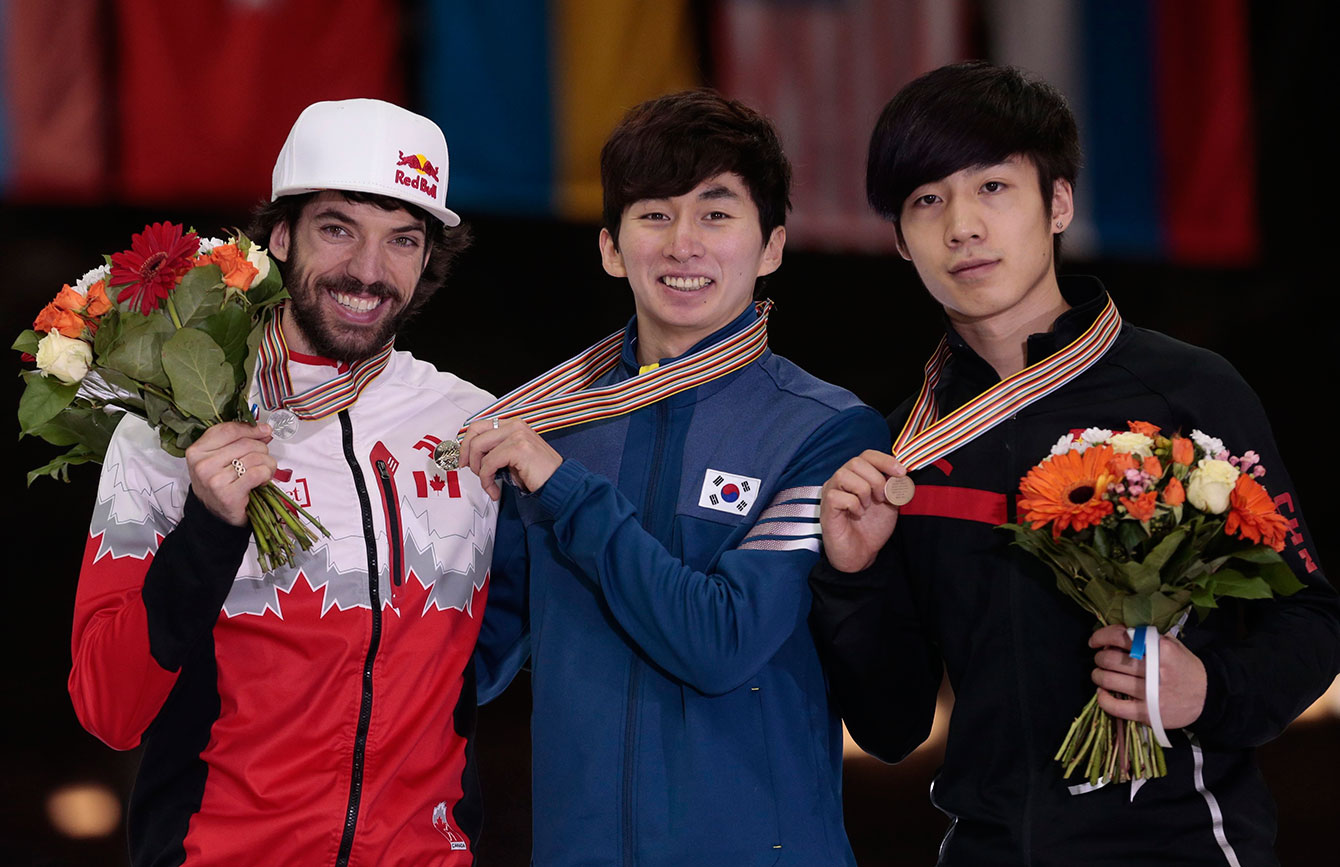 From left, silver medallist Charles Hamelin, of Canada, gold medallist Park Se Yeong, of Korea, and bronze medallist Shi Jingnan, of China, pose with their medals for men's the 1000m race at the short track world championships, in Moscow, Russia, on Sunday, March 15, 2015. (AP Photo/Ivan Sekretarev)
