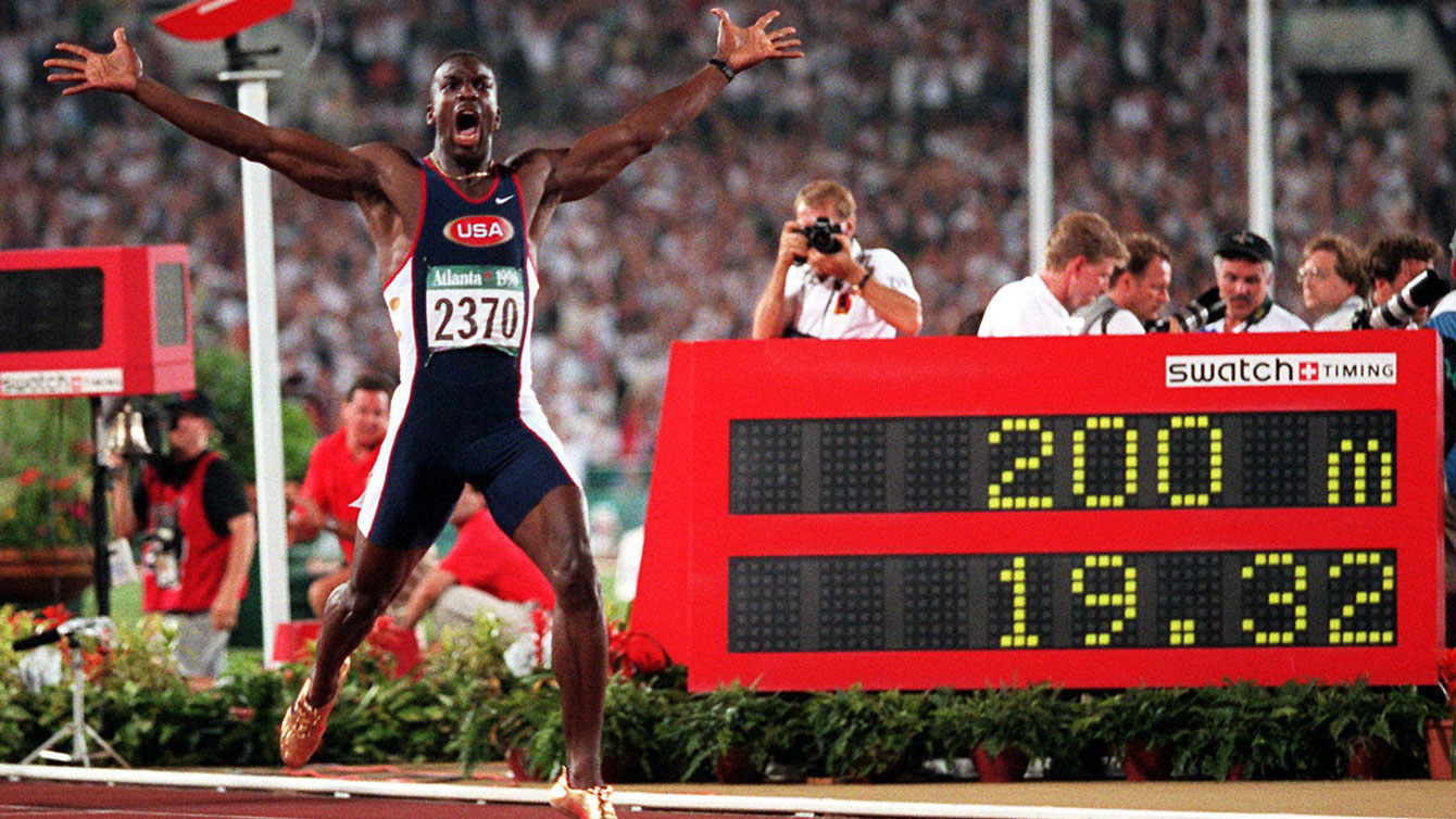 Michael Johnson celebrates setting the 200m World Record, shattering and resetting his own previous best from 19.66 to 19.32.