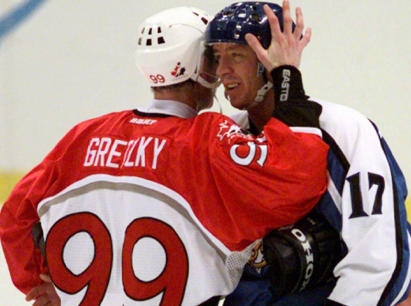 Jari Kurri (17) embraces his longtime NHL teammate Wayne Gretzky after Finland beat Canada for bronze medal in men's ice hockey at Nagano 1998.