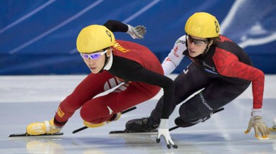Fan Kexin from China (9) skates to a first place finish ahead of Marianne St-Gelais from Canada during the women's 500-metre final race at the ISU World Cup Short Track Speedskating competition in Montreal, Saturday, November 15, 2014. THE CANADIAN PRESS/Graham Hughes