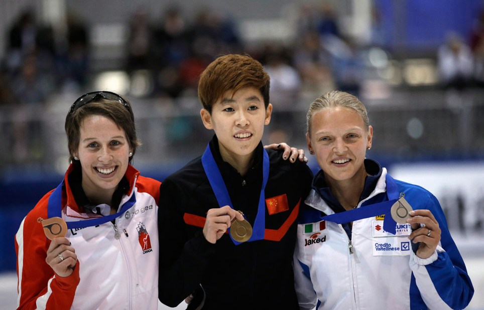 First-place finisher Fan Kexin Fan, center, of China; second-place Arianna Fontana, right, of Italy; and third-place Marianne St-Gelais, left, of Canada, celebrate with their medals following the women's 500 meters at the World Cup short track speedskating event Sunday, Nov. 9, 2014, in Kearns, Utah. (AP Photo/Rick Bowmer)