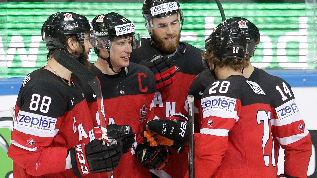 Sidney Crosby (with 'C' on shirt) and team celebrate at IIHF worlds. 