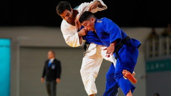 Two judokas grapple while standing