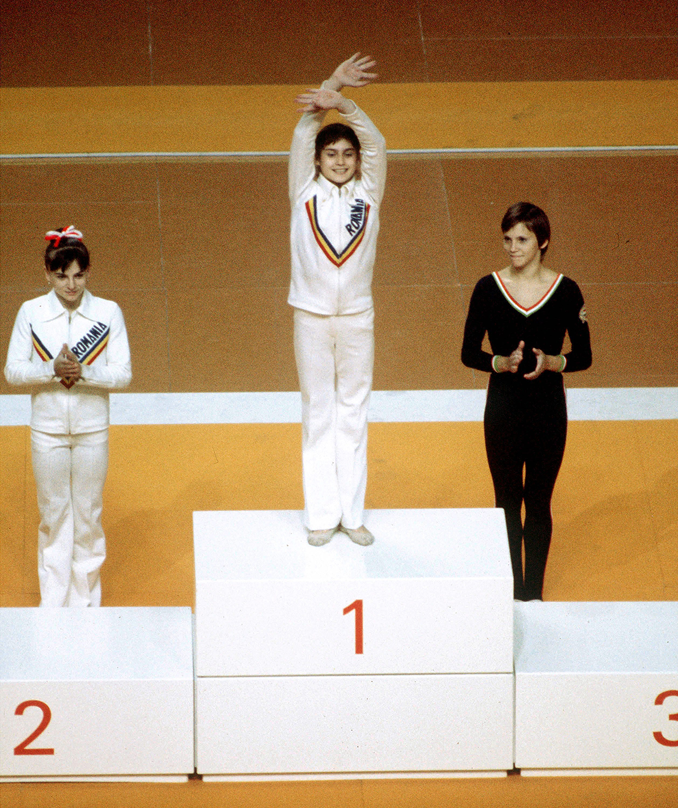 Then 14-year-old Nadia Comaneci (centre) on the podium after winning gold in the uneven bars at Montreal 1976. 