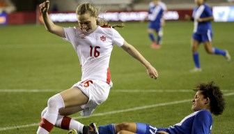 Guatemala's Didra Martinez challenges Canada's Gabrielle Carle for the ball during the second half of a CONCACAF Olympic qualifying tournament