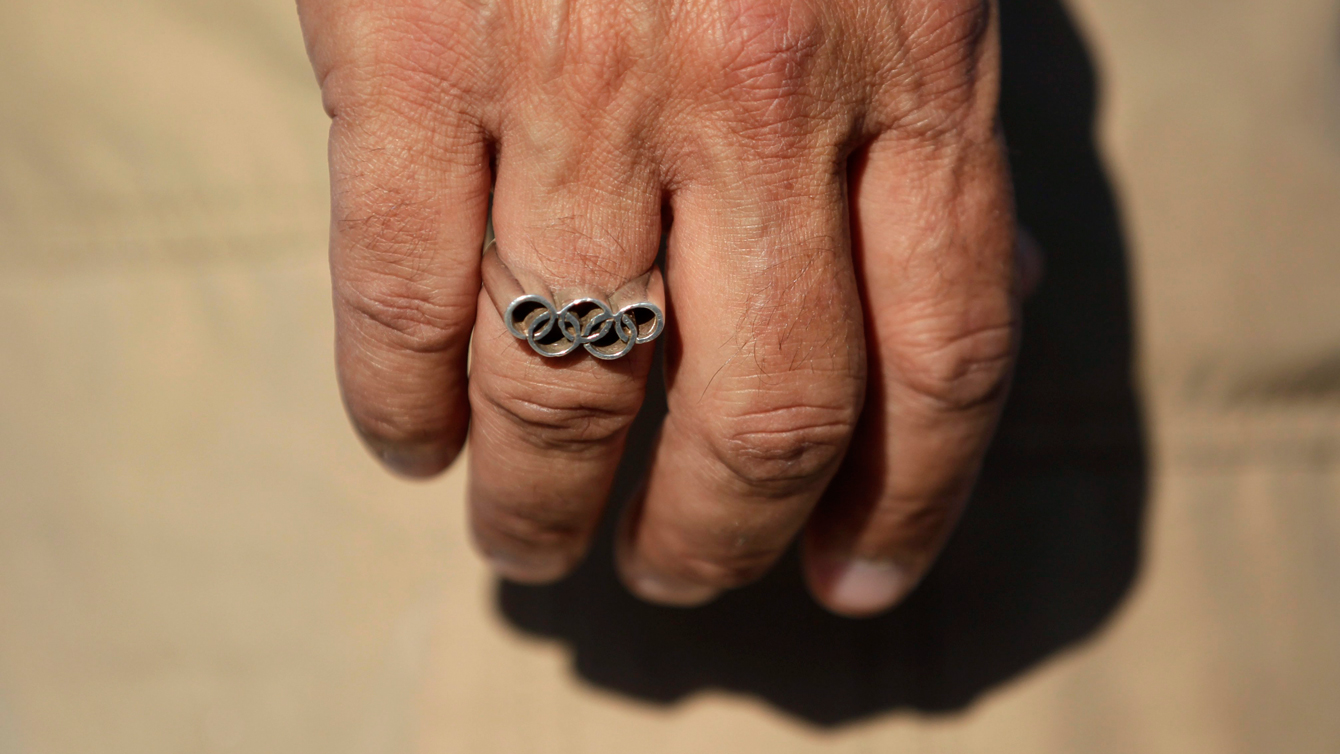 Grege Louganis' Olympic rings, pictured on February 1, 2011 while training divers in Fullerton, California (Photo: AP/Jae C. Hong).