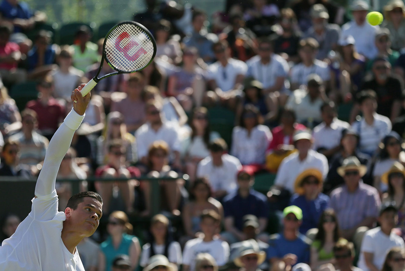 Milos Raonic serves against Daniel Gimeno-Traver of Spain on June 29, 2015 at Wimbledon. 