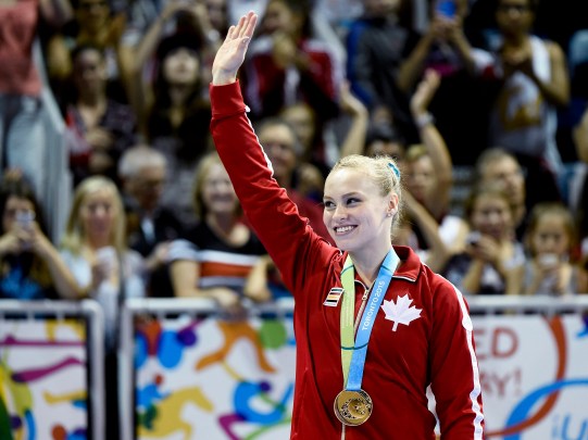 Canada's Ellie Black shows off her gold medal at the women's artistic all around gymnastics competition during the Pan American Games in Toronto on Monday, July 13, 2015. THE CANADIAN PRESS/Nathan Denette
