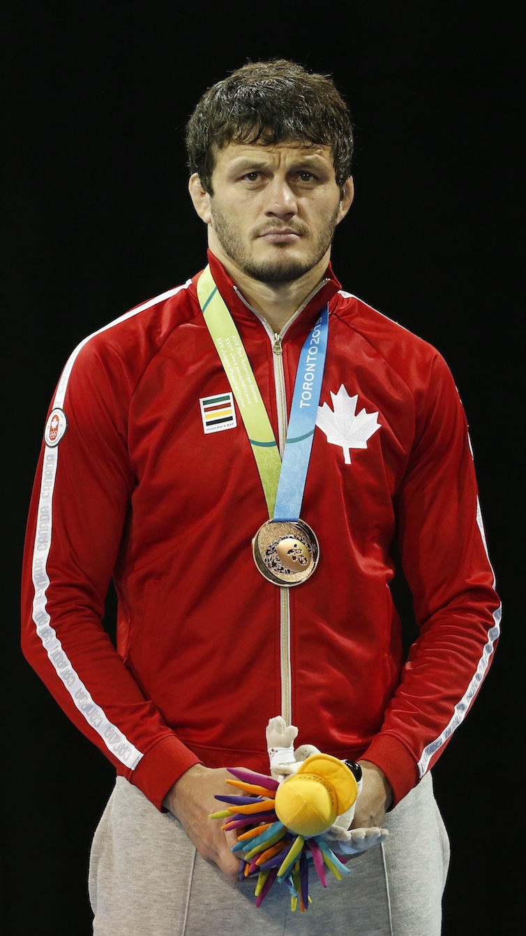 Canada's Tamerlan Tagziev wears his bronze medal earned in the men's freestyle 86 kg wrestling competition at the Pan Am Games, Saturday, July 18, 2015, in Mississauga, Ontario. Photo by AP Photo/Julio Cortez