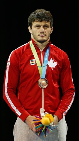 Canada's Tamerlan Tagziev wears his bronze medal earned in the men's freestyle 86 kg wrestling competition at the Pan Am Games, Saturday, July 18, 2015, in Mississauga, Ontario. Photo by AP Photo/Julio Cortez