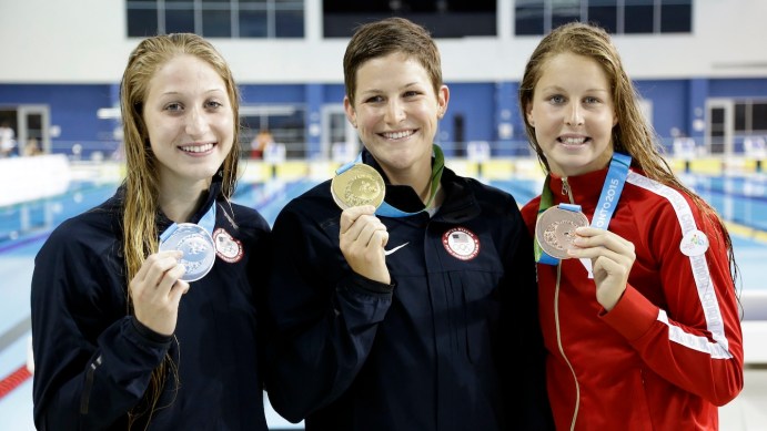 Gold medalist Caitlin Leverenz, center, of the United States, poses with silver medalist Meghan Small, left, of the United States, and bronze medalist, Sydney Pickrem, right, of Canada, after the women's 200 meter individual medley swimming event at the Pan Am Games Sunday, July 19, 2015, in Toronto. Photo by AP Photo/Mark Humphrey