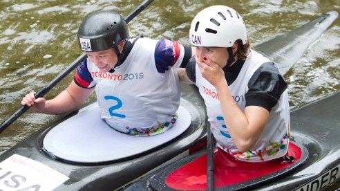 Canada's Jazmyne Denhollander (right) reacts with US Ashley Nee after crossing the finish line in the Women's Kayak (K1) final at the Minden White Water Preserve.