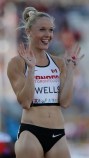 Sarah Wells, of Canada, waves to a camera before running in the finals