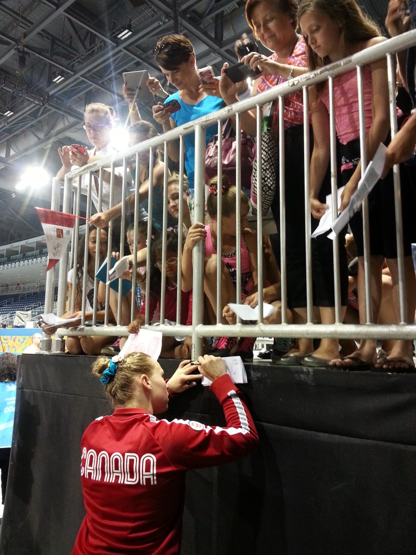 Ellie Black signs autographs after winning the women's artistic all around gymnastics competition during the Pan American Games in Toronto on Monday, July 13, 2015.