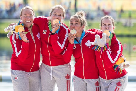 Members of Canada's K4 500m team celebrate winning the first gold medal of the Pan Am Games in Toronto