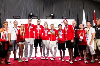 Horn-Miller (far left) celebrates with athletes at a Canada House medal celebration.