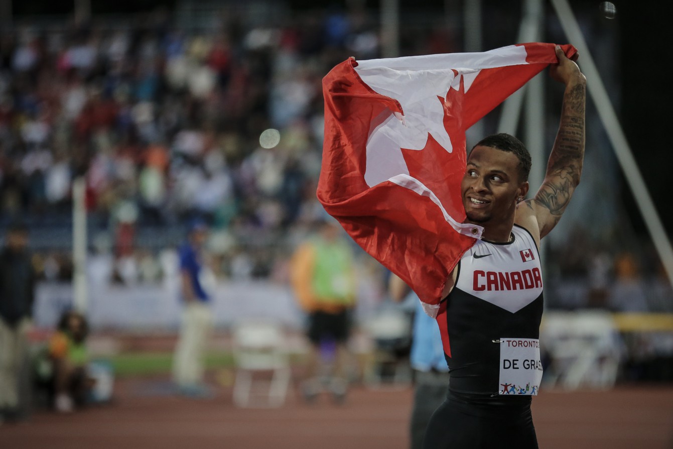 Andre De Grasse celebrates after winning the men's 100m in Toronto, Ontario (Alexandra Fernando for COC). 