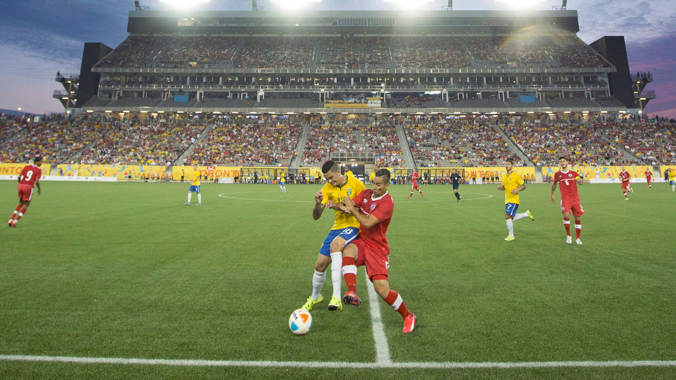 Molham Babouli (in red) was Canada's lone goalscorer in 4-1 Pan Am football loss to Brazil on July 12, 2015. 