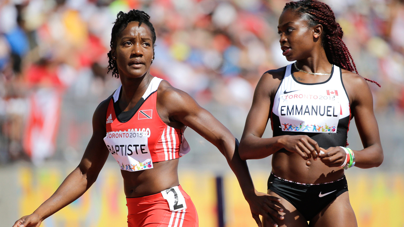 Kelly Ann Baptiste (left) looks at the scoreboard after heats, next to Canada's Crystal Emmanuel, who also advanced to the Pan Am Games 100m semifinals on July 21, 2015.