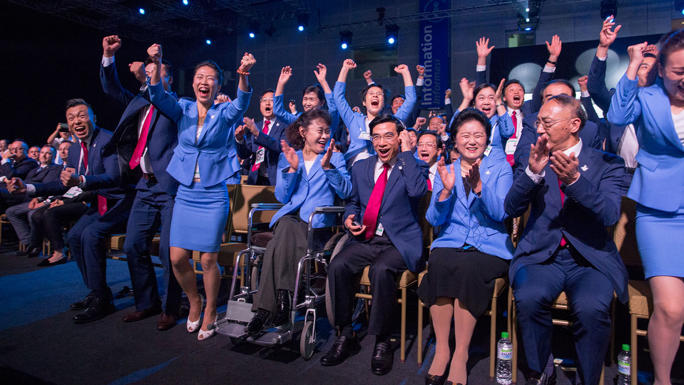 Beijing 2022 delegates at the 128th IOC Session celebrate the announcement of being awarded the Olympic and Paralympic Games (Photo: IOC Media).