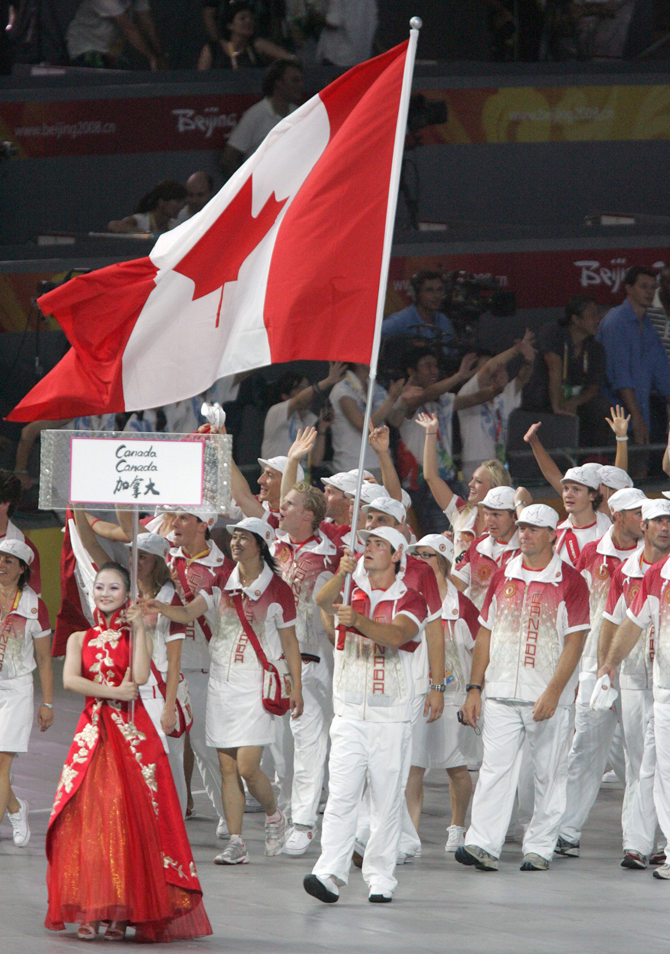 Adam van Koeverden carries the flag in the opening ceremony