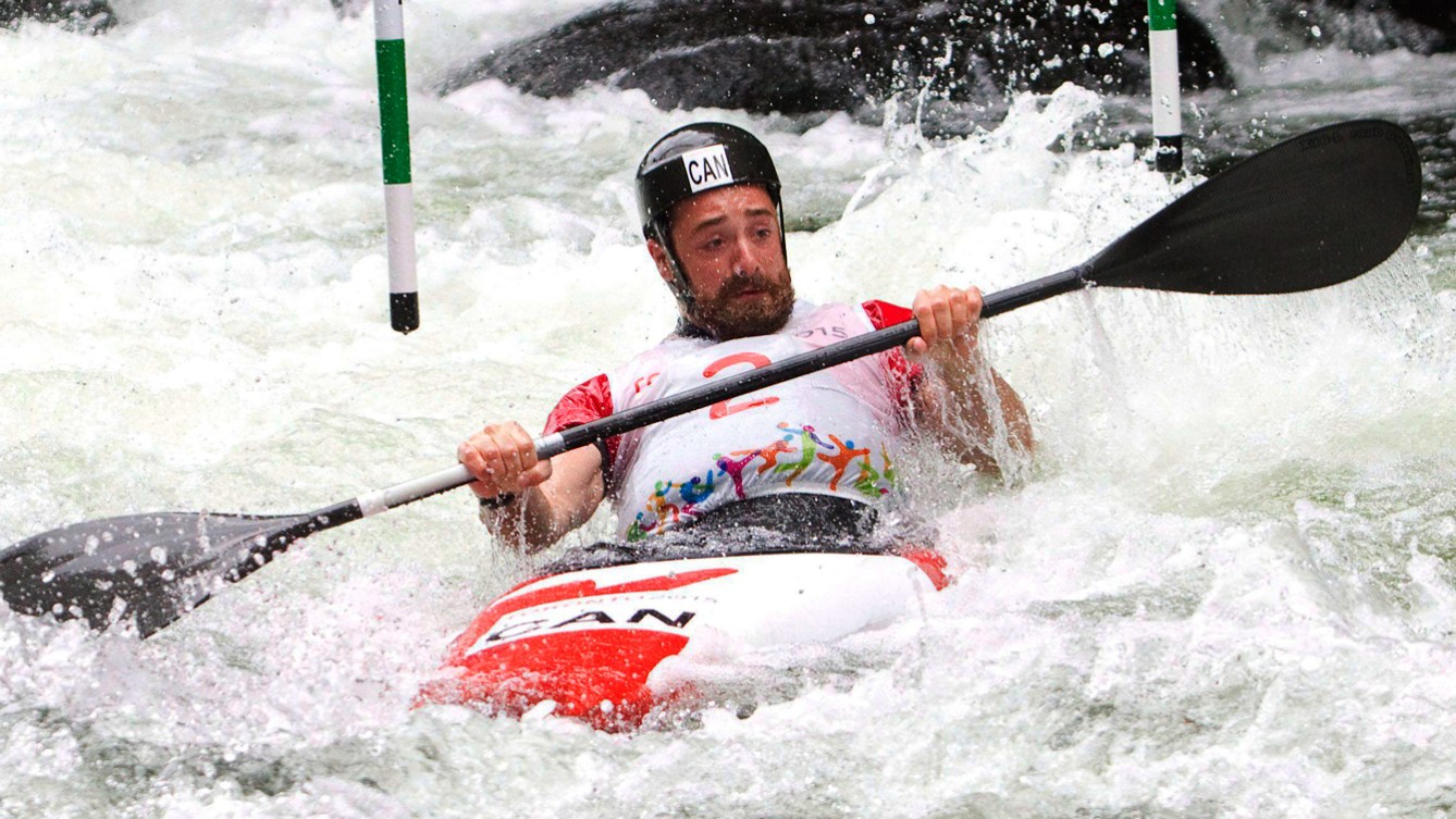 Ben Hayward runs the white water course in the Men's Kayak (K1) category at the Pan American Games in Minden, Ont.