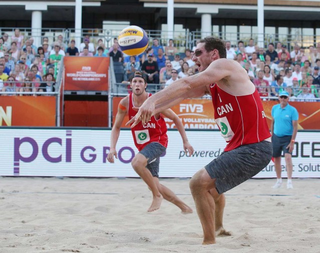 Josh Binstock (dig) during round of 32 action at 2015 FIVB beach worlds. (Photo: FIVB)