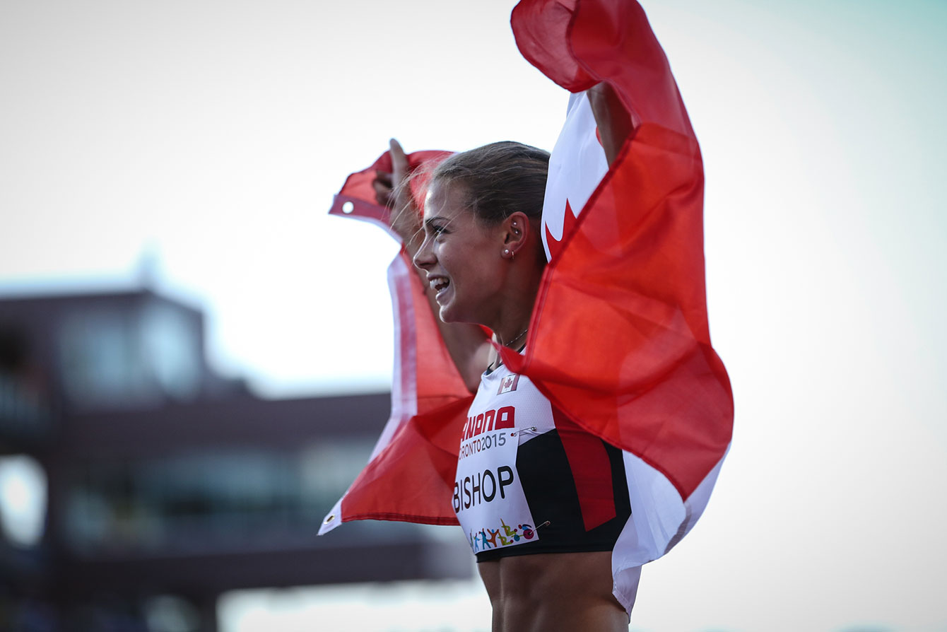Melissa Bishop takes a victory lap with the Canadian flag after winning the women's 800m at the Pan Am Games on July 22, 2015.