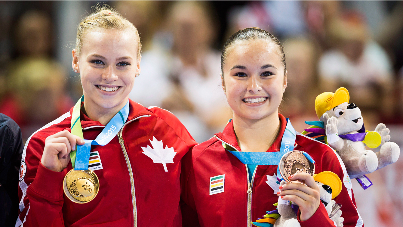 Ellie Black, right, holds her gold medal and Victoria Woo, holding her bronze, following the during the artistic gymnastics balance beam at the Pan Am Games on July 15, 2015. (Photo: Mark Blinch, Canadian Press)