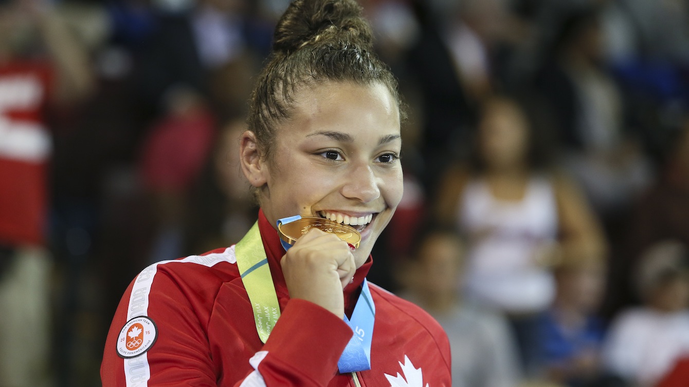 Braxton Stone-Papadopoulos biting her medal