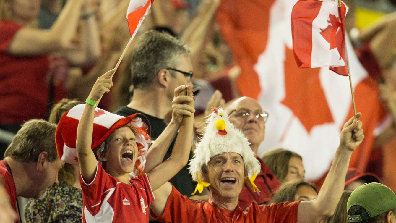 Fans in Hamilton celebrate as Canada routs Ecuador 5-2 in the women's football opener of the Pan Am Games on July 11, 2015. 