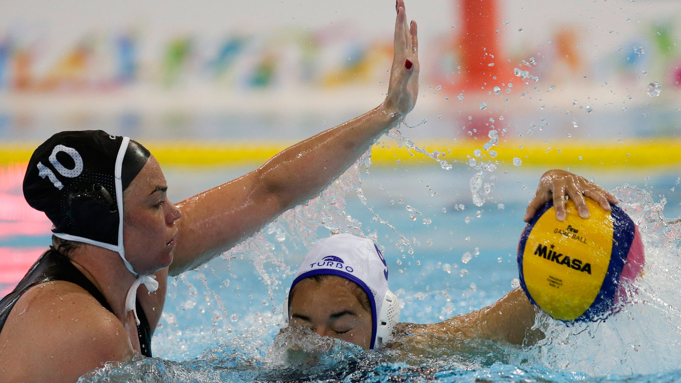 Christine Robinson (left) goes to block during a water polo match at the Toronto 2015 Pan Am Games
