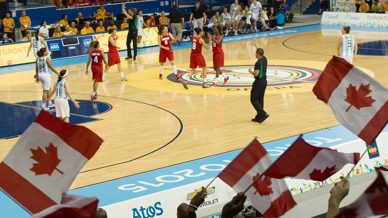 Canada fans wave the maple leaf in a Toronto 2015 Pan American Games women's basketball game against Argentina. 